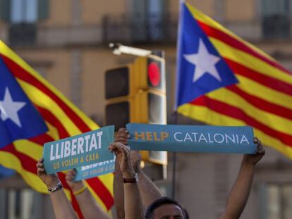 Dos personas lenvantan sus pancartas en la manifestaci&oacute;n convocada por la Mesa por la Democracia en Barcelona.