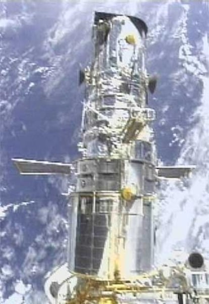 El telescopio <i>Hubble</i>, sujeto a un transbordador, en 2002.