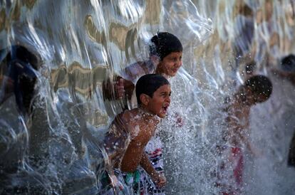 Un grupo de niños juegan con el agua en el parque Madureria de Río de Janeiro (Brasil).