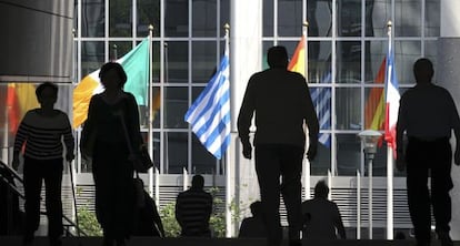 Viandantes en las escaleras del Parlamento Europeo en Bruselas donde ondean las banderas de la UE