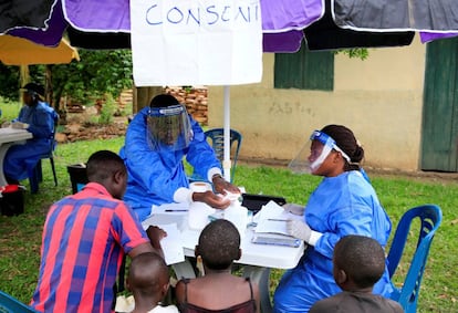 Trabajadores sanitarios de Uganda hablan con civiles sobre el brote de ébola en la aldea de Kirembo, cerca de la frontera con el Congo.