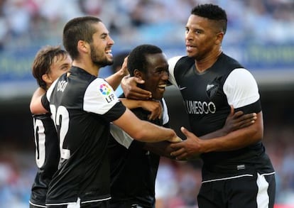 Málaga players mob 16-year-old goalscorer Fabrice Olinga.