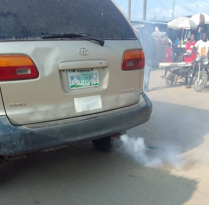 Salida de humo blanco del tubo de escape de un vehículo, en Nigeria.