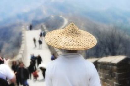 Un hombre con sombrero de paja en la Gran Muralla china.