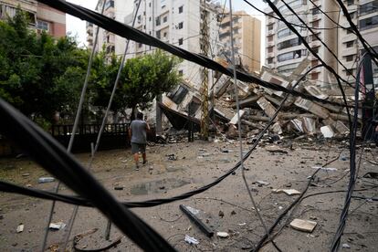 Un hombre camina junto a un edificio colapsado tras un ataque israelí sobre Beirut, este martes.