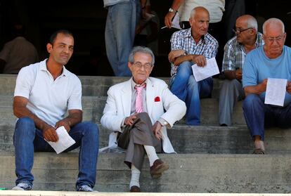 Racegoer Elias Yousef (2nd L) attends a horse race at Beirut Hippodrome, Lebanon, June 18, 2017. REUTERS/Jamal Saidi   SEARCH "SAIDI HIPPODROME" FOR THIS STORY. SEARCH "WIDER IMAGE" FOR ALL STORIES.