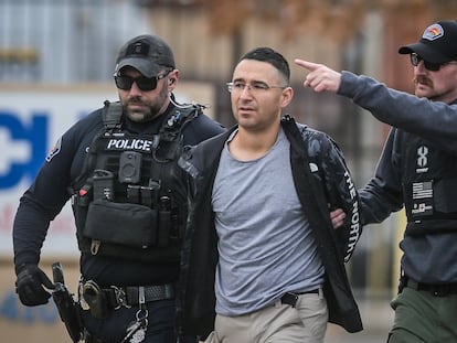 Solomon Peña, center, a Republican candidate for New Mexico House District 14, is taken into custody by Albuquerque Police officers, on Monday, in southwest Albuquerque.
