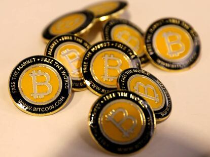 FILE PHOTO: Bitcoin.com buttons are seen displayed on the floor of the Consensus 2018 blockchain technology conference in New York City