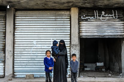 Malika Jadr Abdallah, de 30 años, posa junto a sus hijos frente a su casa. Pudo volver un mes y medio después de que terminaran los combates en Gewayran, debido a la cercanía de su hogar y la prisión. La mayor parte de la casa está destrozada, no hay puertas ni ventanas, pero vive allí con sus tres hijos, sin muebles y rodeada de humedad y oscuridad. La mujer culpa a los 'bulldozers' que utilizaron las autoridades kurdas.