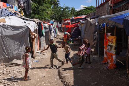 Children play on a field set up at a school for people displaced by gang violence, in Port-au-Prince, on October 31, 2024.