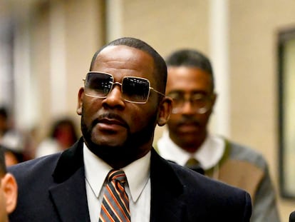 Musician R. Kelly, center, leaves the Daley Center after a hearing in his child support case on May 8, 2019, in Chicago.