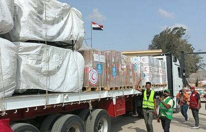 Egyptian Red Crescent members and volunteers next to a truck carrying humanitarian aid through the Rafah crossing on October 22, 2023.