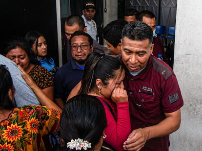 A woman cries as she hugs a deported relative at the gate of the Guatemalan Air Force (FAG) airport, in Guatemala City, on May 25.