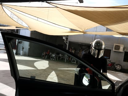 A worker dressed as a 'Star Wars' character works at a themed car wash service called 'Star Wash', in Santiago, Chile, December 26, 2023.