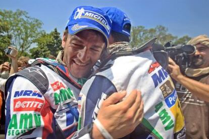 Marc Coma es felicitado por su compañero Joan Pedrero tras su victoria en el Dakar en motos, la tercera de su carrera.