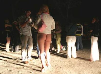 Un policía de paisano estudia la documentación de una prostituta en la Casa de Campo.