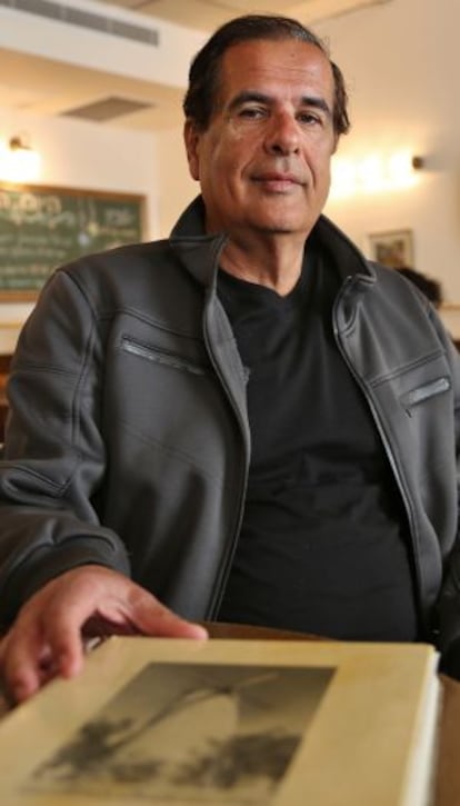 Isaac Levy with his Sephardic family book in a Jerusalem café.