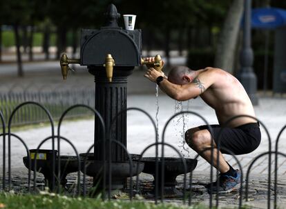 Un hombre se refresca este lunes en una fuente del parque del Retiro, en Madrid. 