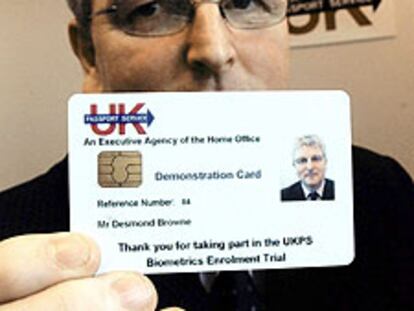El ministro de Inmigración británico, Des Brown, muestra el nuevo carnet.