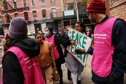 An anti-abortion activist attempts to block a woman from entering the Planned Parenthood Manhattan Health Center in New York City, U.S., December 2, 2023.