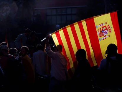 A protestor in Barcelona with the Spanish and Catalan flags.