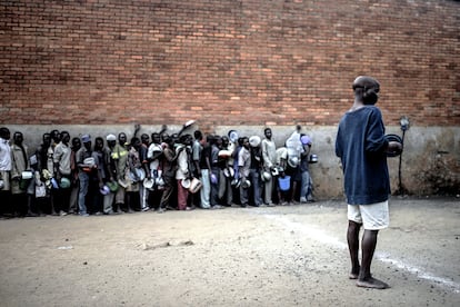 Un grupo de presos espera en fila a que les sirvan su única comida del día en la prisión de Chichiri, Malawi, el pasado 20 de junio. / Luca Sola para MSF