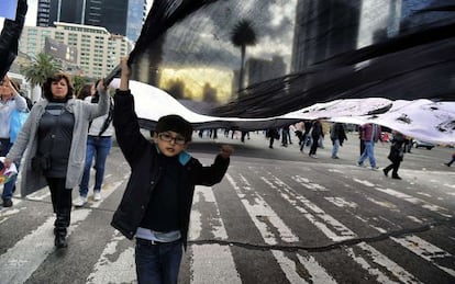 A child marches in a protest held to remember the 43 murdered students in Iguala.