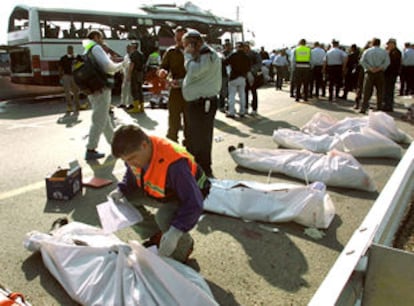 Un sanitario identifica a uno de los ocho muertos que provocó el atentado suicida palestino de ayer en la ciudad porteña de Haifa.