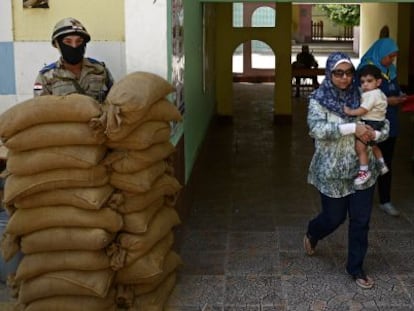 Uma mulher caminha depois de votar em al-Manial, um subúrbio do Cairo.