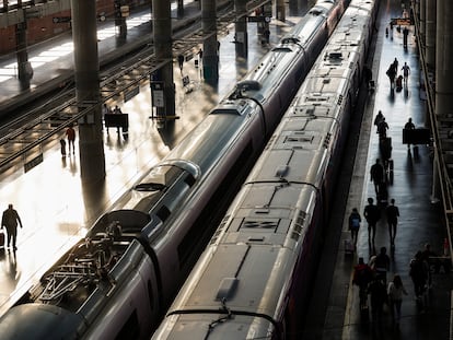 Varias personas esperan en los andenes de la estación de Atocha (Madrid).
