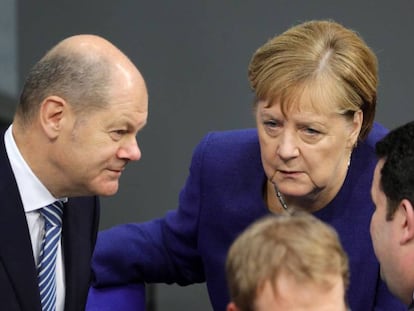 La canciller alemana, Angela Merkel, con el ministro de Finanzas, Olaf Scholz (izq.) este jueves en el Parlamento en Berlín.