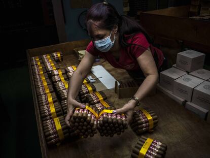 Una trabajadora empaqueta puros en la fábrica de puros Partagás en La Habana, Cuba, el jueves 11 de marzo de 2021.