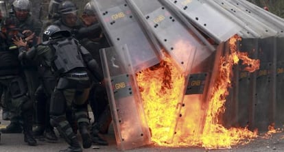 National guards react to a Molotov cocktail thrown by students during a protest
