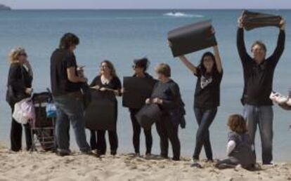 Un grupo de personas de las que han formado esta mañana en la Playa de Palma una cadena humana en contra de las prospecciones en el mediterráneo.