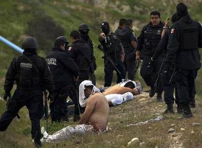 Policías federales mexicanos custodian a varios sospechosos de un tiroteo, el pasado lunes en Tijuana.