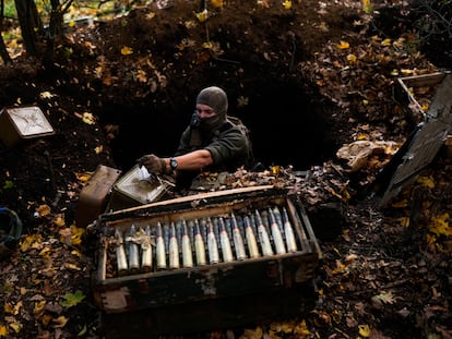 A Ukrainian territorial defence deminer takes Russian ammunition left behind as his team clears mines near Grakove village, Ukraine, Thursday, Oct. 13, 2022. (AP Photo/Francisco Seco)