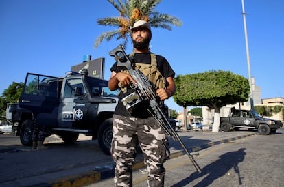 A member of the Security personnel affiliated with the Ministry of Interior secures the street after yesterday's clashes between armed factions in Tripoli, Libya, August 16, 2023.