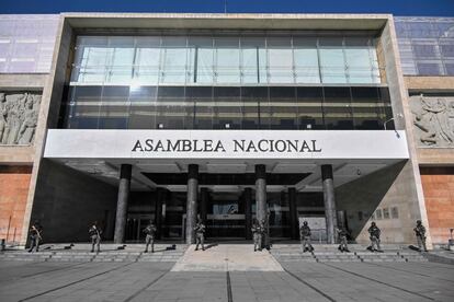 Police officers stand guard outside the Ecuadorian National Assembly in Quito on May 17.