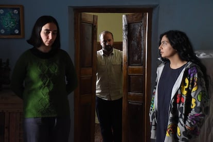 Mahsa Rostami (l) and Setareh Maleki (r), the two daughters in Mohammad Rasoulof's 'Seed of the Sacred Fig,' with Missagh Zareh, who plays the father, in the background.