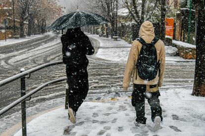 Varias personas en las las calles nevadas de la región mallorquina de Valldemossa.