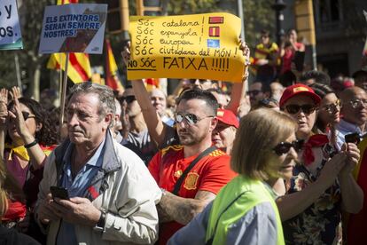 A protestor holds a banner reading: “I am Catalan! I am Spanish! I am European! I am a citizen of the world! I am not a fascist!!"