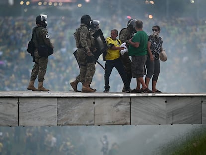 Members of the Brazilian security forces detain pro-Bolsonaro protestors at the Planalto Palace in Brasília, on Sunday, January 8, 2023.