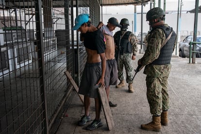 Military personnel search passers-by on the streets of Guayaquil.