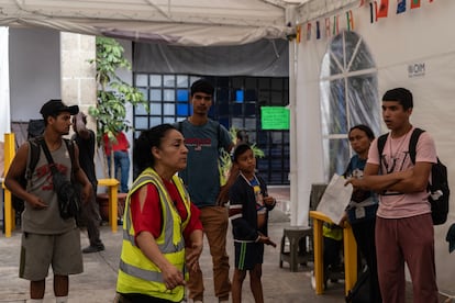 Claudia Torres, shelter coordinator, gives instructions to a newly-arrived group of migrants.