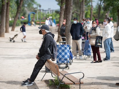 Un hombre espera en una de las colas para recoger comida de Caritas en Aluche (Madrid), el pasado mes de abril.