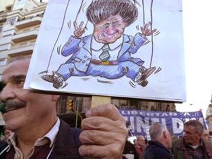 Un hombre muestra una caricatura del presidente Duhalde durante una manifestación ayer en Buenos Aires.