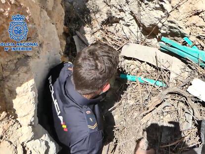 Un agente de la Policía Nacional baja por la entrada a una cueva de Baza en la que se plantaba marihuana