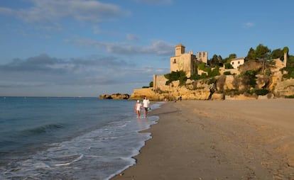 Paseantes en la playa de Tamarit (Tarragona), junto al castillo homónimo, el pasado martes.