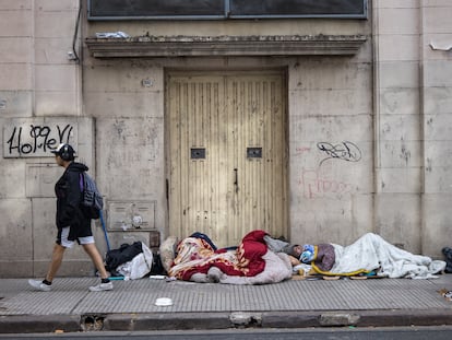 Personas sin hogar duermen frente a la entrada de un edificio, en Buenos Aires, en 2024.