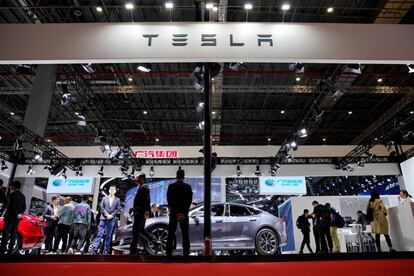 FILE PHOTO: People visit a Tesla booth during the media day for the Shanghai auto show in Shanghai